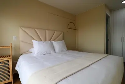 a bedroom with a large white bed with white pillows at Stunning 2BR with Balcony & City Views in Lima