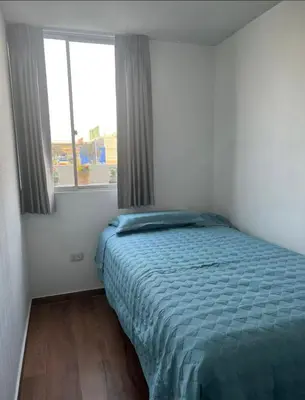 a bedroom with a bed and a large window at Departamento cómodo a 20 minutos del aeropuerto in Lima