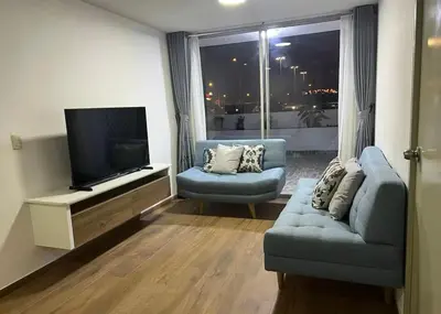 a living room with a flat screen tv and a couch at Departamento cómodo a 20 minutos del aeropuerto in Lima