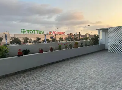 a balcony with potted plants on the side of a building at Departamento cómodo a 20 minutos del aeropuerto in Lima