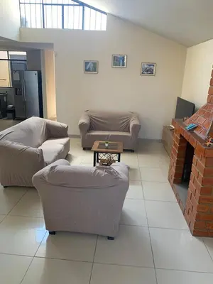 a living room with two couches and a fireplace at Apartamento cerca a lugares turísticos en Ica para 5 personas in Ica