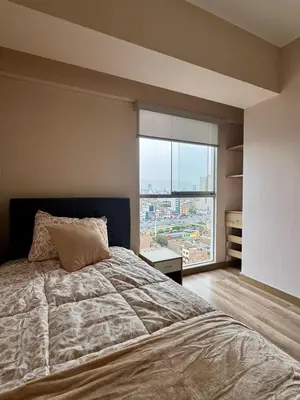 a bedroom with a large bed and a large window at Large Apartment - Santa Beatriz 3 Bedrooms in Lima