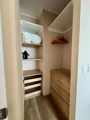 a walk in closet with wooden floors and shelves at Large Apartment - Santa Beatriz 3 Bedrooms in Lima