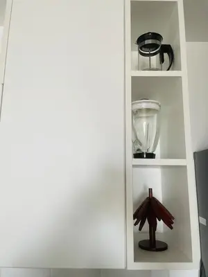 a white book shelf with a bowl and a blender at Apartamento moderno en Miraflores in Lima