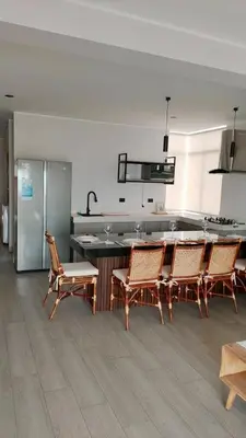a kitchen with chairs and a table and a counter at Punta Caleta Punta Hermosa in Punta Hermosa