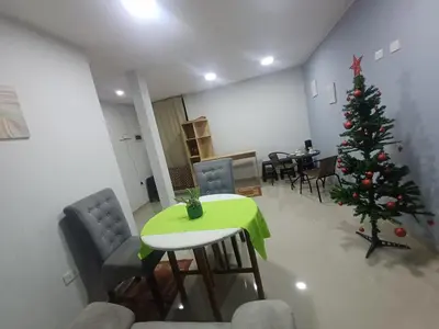 a christmas tree in a room with a green table and chairs at La Casa de la Emperatriz in Ica