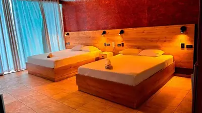 a bedroom with two beds in a room at Club InkaVida - Pachacamac in Pachacamac