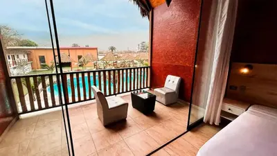 a room with a balcony with a view of a pool at Club InkaVida - Pachacamac in Pachacamac
