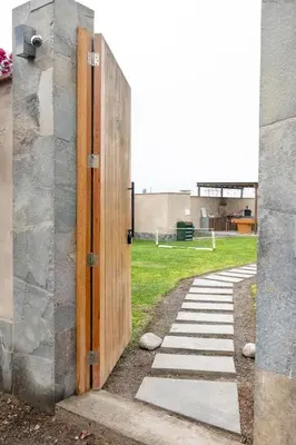 an open door to a building with a grass field at Casa Cieneguilla in Cieneguilla