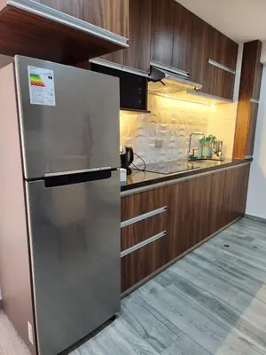 a kitchen with a refrigerator and a sink at Lama Vista Living 302 in Cusco
