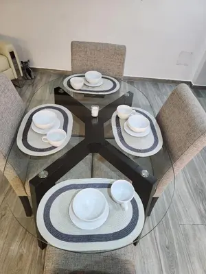 a table with four chairs and white dishes on it at Lama Vista Living 302 in Cusco