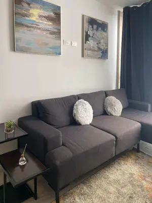 a living room with a gray couch and a table at Barranco Bohemio, Modern and Bright Apartment in Lima