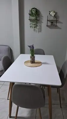 a white dining table with chairs and a plant on it at Sweet Home in Lima