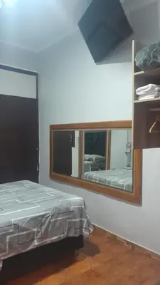 a bedroom with a mirror and a bed in it at HotelesR20 in Lima