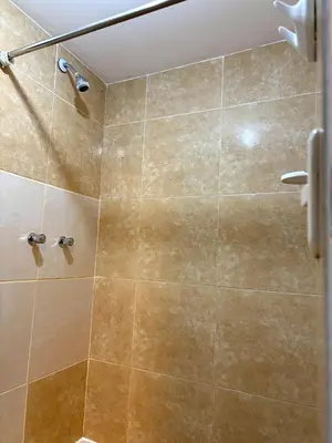a bathroom with a shower with a glass door at Cusco - Flor de Loto in Cusco