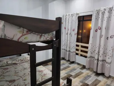 a bedroom with two bunk beds and a window at Ocean Glips II in Punta Negra