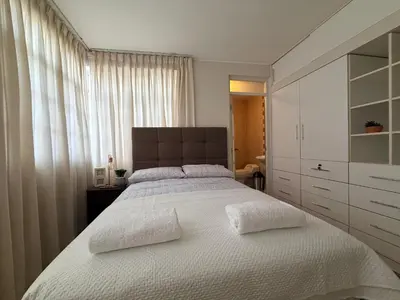 a bedroom with a large bed with two white pillows at Huacachina Boutique Hotel in Ica