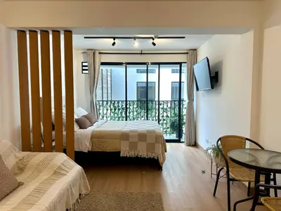 a bedroom with a bed and a balcony at Mini Patria - Cozy apartment in Barranco in Lima