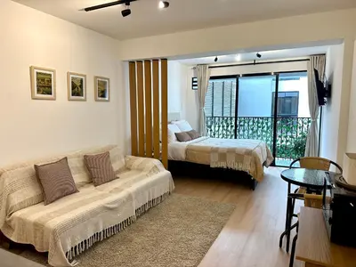 a living room with a couch and a bed at Mini Patria - Cozy apartment in Barranco in Lima