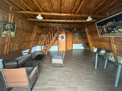 a room with chairs and a staircase in a building at Cabaña las Palmeras de Chincha