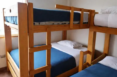 two bunk beds in a room with a blue bed at Casa Matta in Sunampe