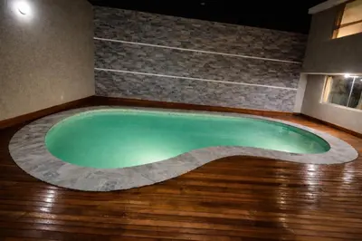 a swimming pool in the middle of a room at Casa Matta in Sunampe