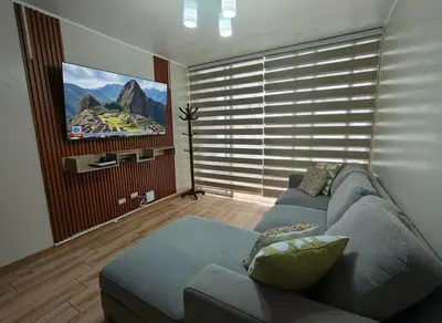 a living room with a couch and a flat screen tv at Costanera Tourist Free Parking 3B 708 in Lima