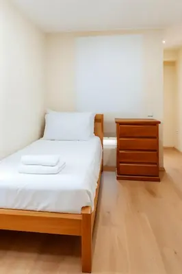 a small bedroom with a bed and a dresser at Costanera Tourist Free Parking 3B 708 in Lima