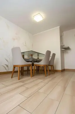 a dining room with white chairs and a table at E SuiteCost FreeParking San Miguel 1B 708 in Lima