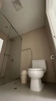 a white bathroom with a toilet and a shower at E Larcomarzone FamilyTourist Laundry 3B 503 in Lima