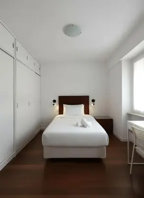 a white bedroom with a white bed and a table at E Larcomarzone FamilyTourist Laundry 3B 503 in Lima