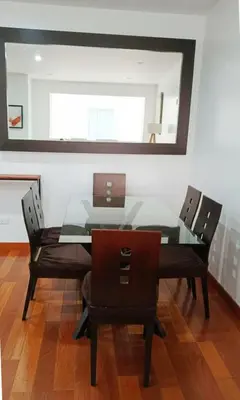 a dining room table with chairs and a glass top at E Larcomarzone FamilyTourist Laundry 3B 503 in Lima