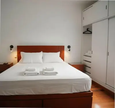 a bedroom with a white bed with two towels on it at E Suite Tourist free Parking Miraflores 1B 503 in Lima