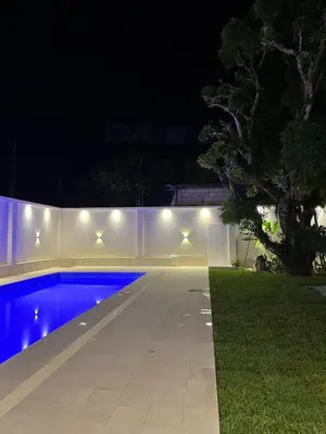 a swimming pool at night with lights on it at Valle Hermoso in San Ramón