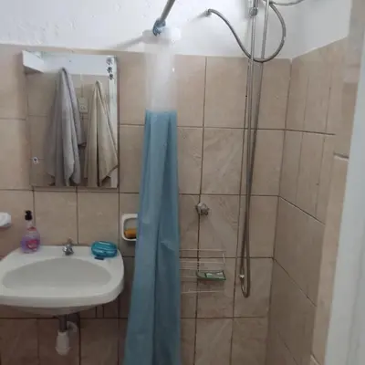 a bathroom with a shower and a sink at La Palmera Apartment in San Bartolo