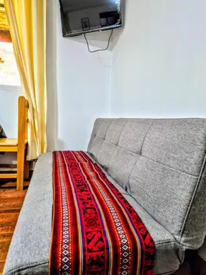 a bedroom with a bed with a rug on it at Loft Rústico 03 en Valle Sagrado in Urubamba