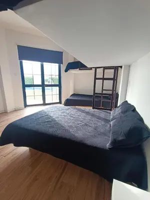 a bedroom with a bunk bed and a ladder at Hermosa casa con piscina privada in Asia