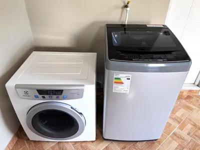 a washer and dryer next to a washing machine at Peruvian Apartments La Angostura in Ica