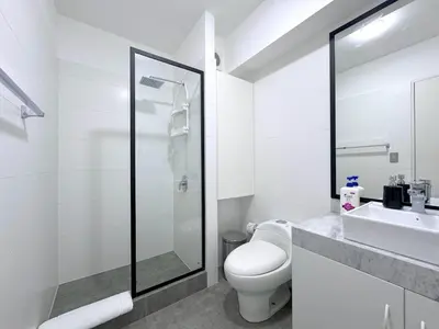 a white bathroom with a toilet and a sink at Peruvian Apartments Barranco 1710 in Lima