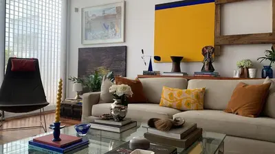 a living room with a couch and a glass table at Huaca Pucllana Design Apartment between Miraflores and San Isidro in Lima