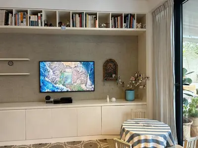 a living room with a tv on a wall at Huaca Pucllana Design Apartment between Miraflores and San Isidro in Lima