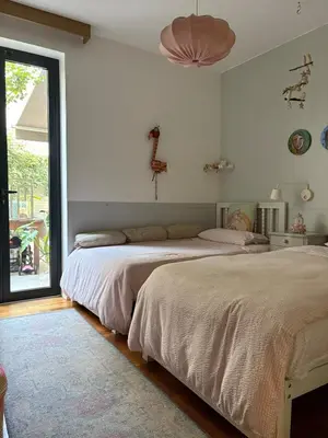 a bedroom with two beds and a large window at Huaca Pucllana Design Apartment between Miraflores and San Isidro in Lima