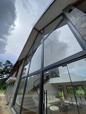 an external view of a house with large windows at Steinhaus - Nature, calm and comfort in Oxapampa