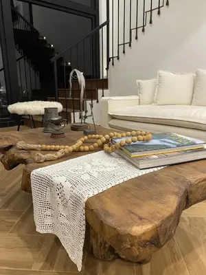 a living room with a wooden coffee table and a couch at Steinhaus - Nature, calm and comfort in Oxapampa