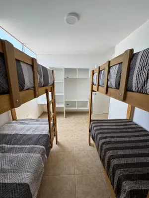 two bunk beds are in a room with at Departamento cerca a la playa 202 in Punta Negra