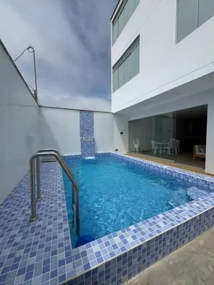 a swimming pool in front of a house at Departamento cerca a la playa 202 in Punta Negra