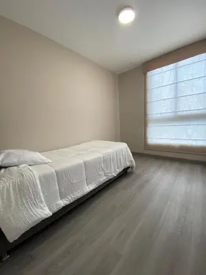 a bedroom with a white bed and a window at Life is better by the sea in Lima