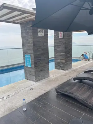 a view of a swimming pool with a bottle of water at Life is better by the sea in Lima