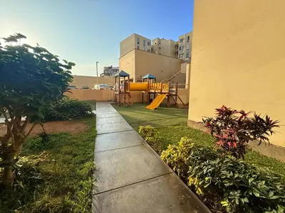 a garden with a playground in a building at Casa Lima Brasil in Lima