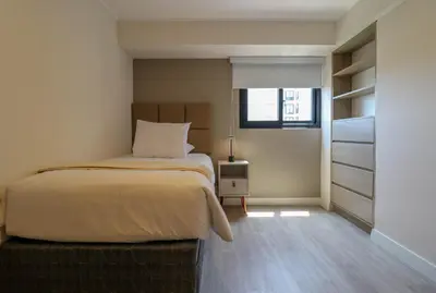 a small bedroom with a bed and a window at Marvelous 2BR with Balcony in Miraflores in Lima